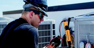 Technician working on HVAC unit